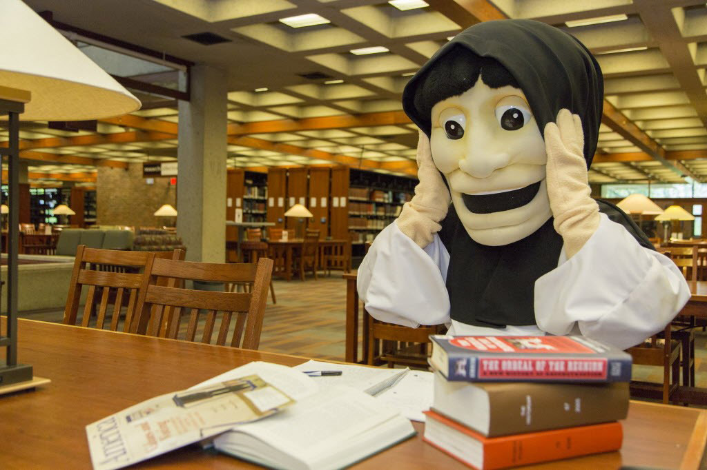 Friars mascot in the library