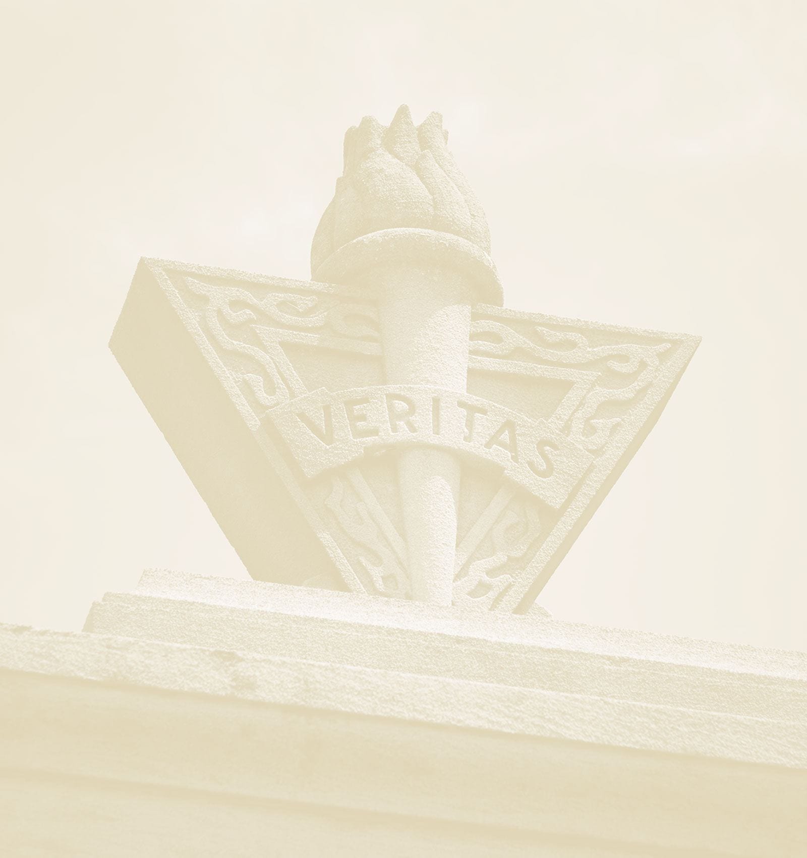 The Veritas logo- a torch of knowledge with the word Veritas over it